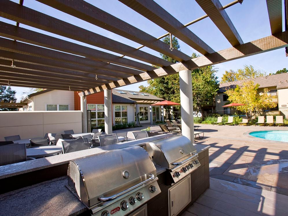 Outdoor lounge with barbecue grills, dining area, swimming pool and sundeck