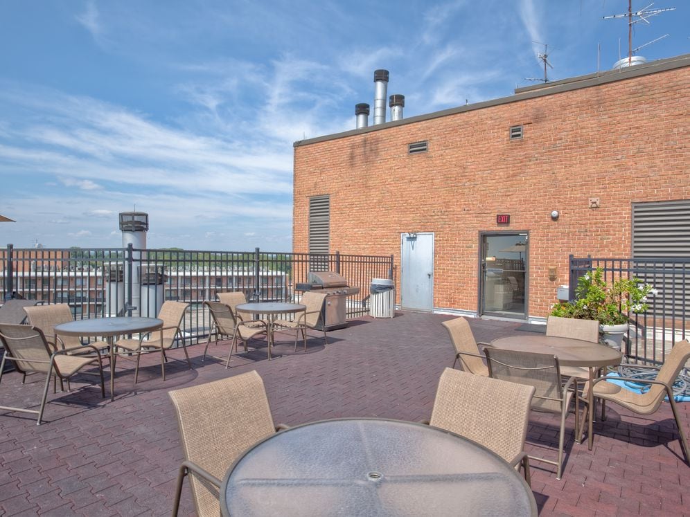 Rooftop dining areas with barbecue grills and seating