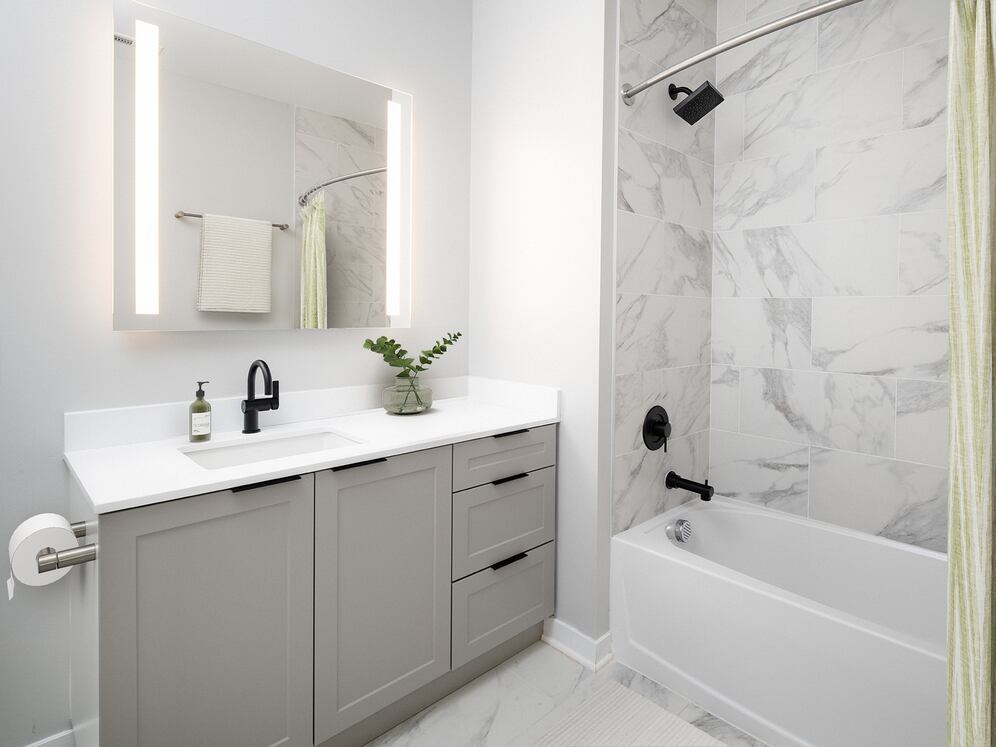 Signature Collection Guest bath with grey shaker cabinetry, white quartz countertop, and LED vanity mirror