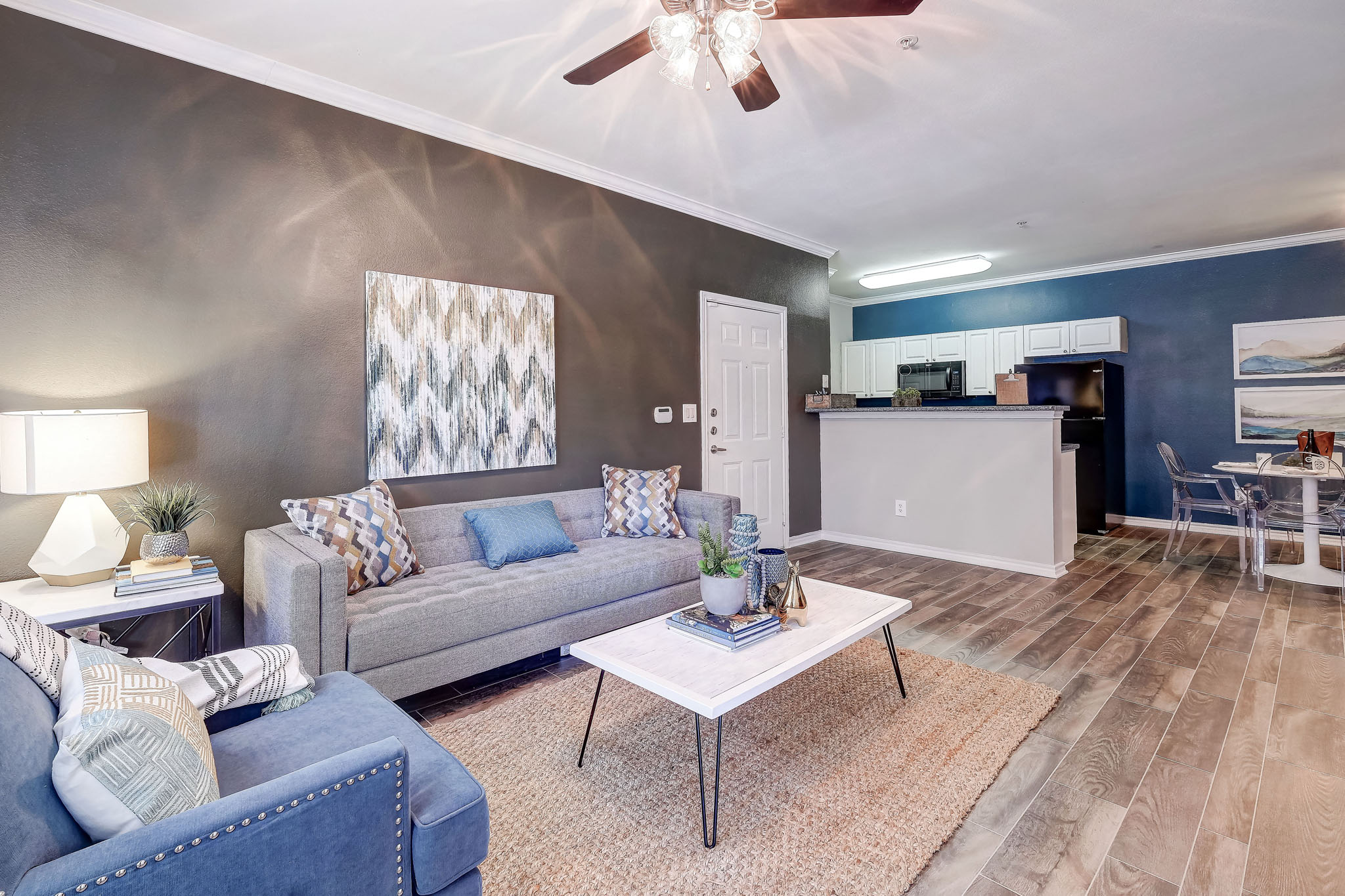 Spacious living room with hard wood floors and high ceilings