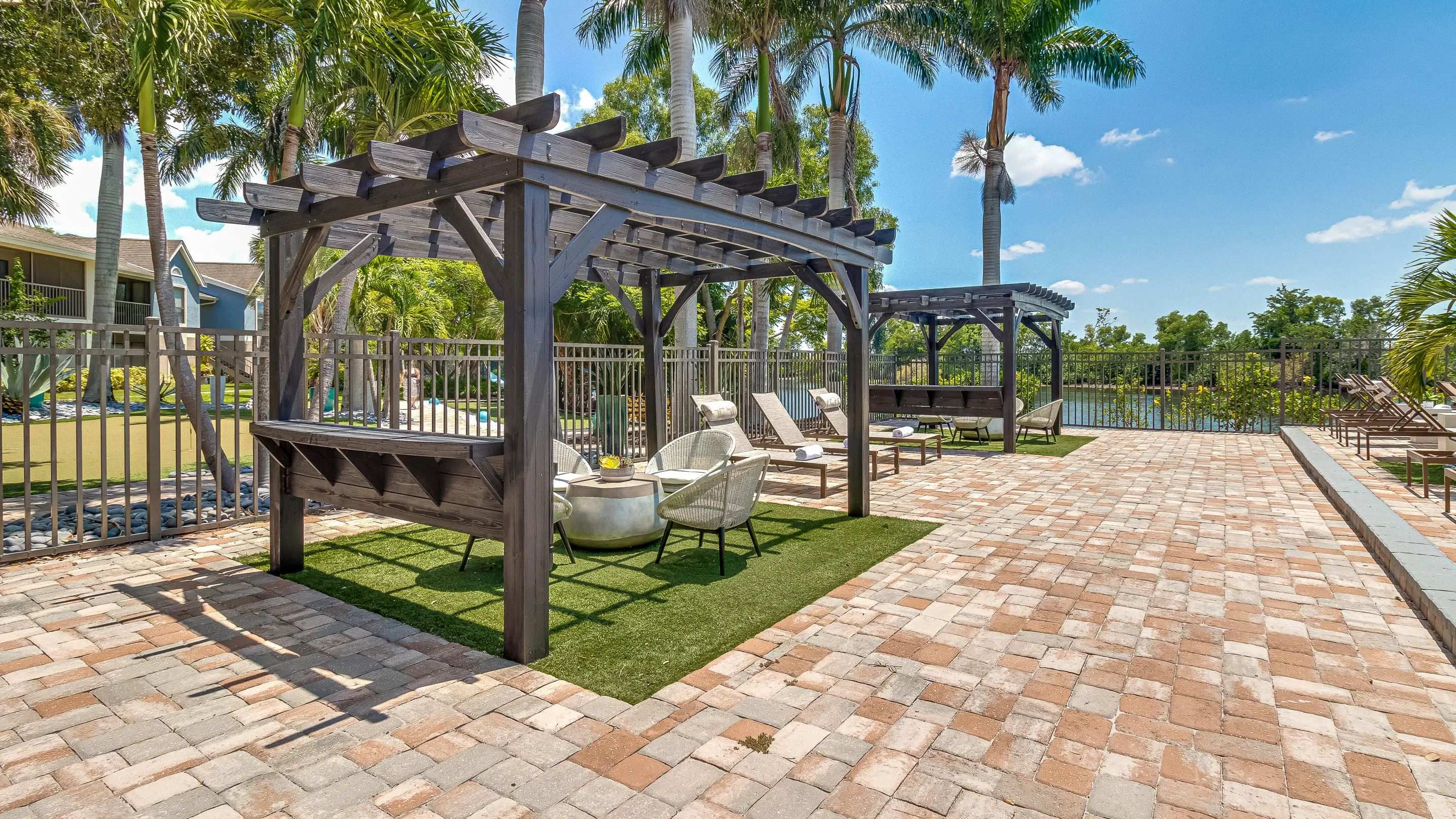 Lounge in style underneath our poolside pergolas! 