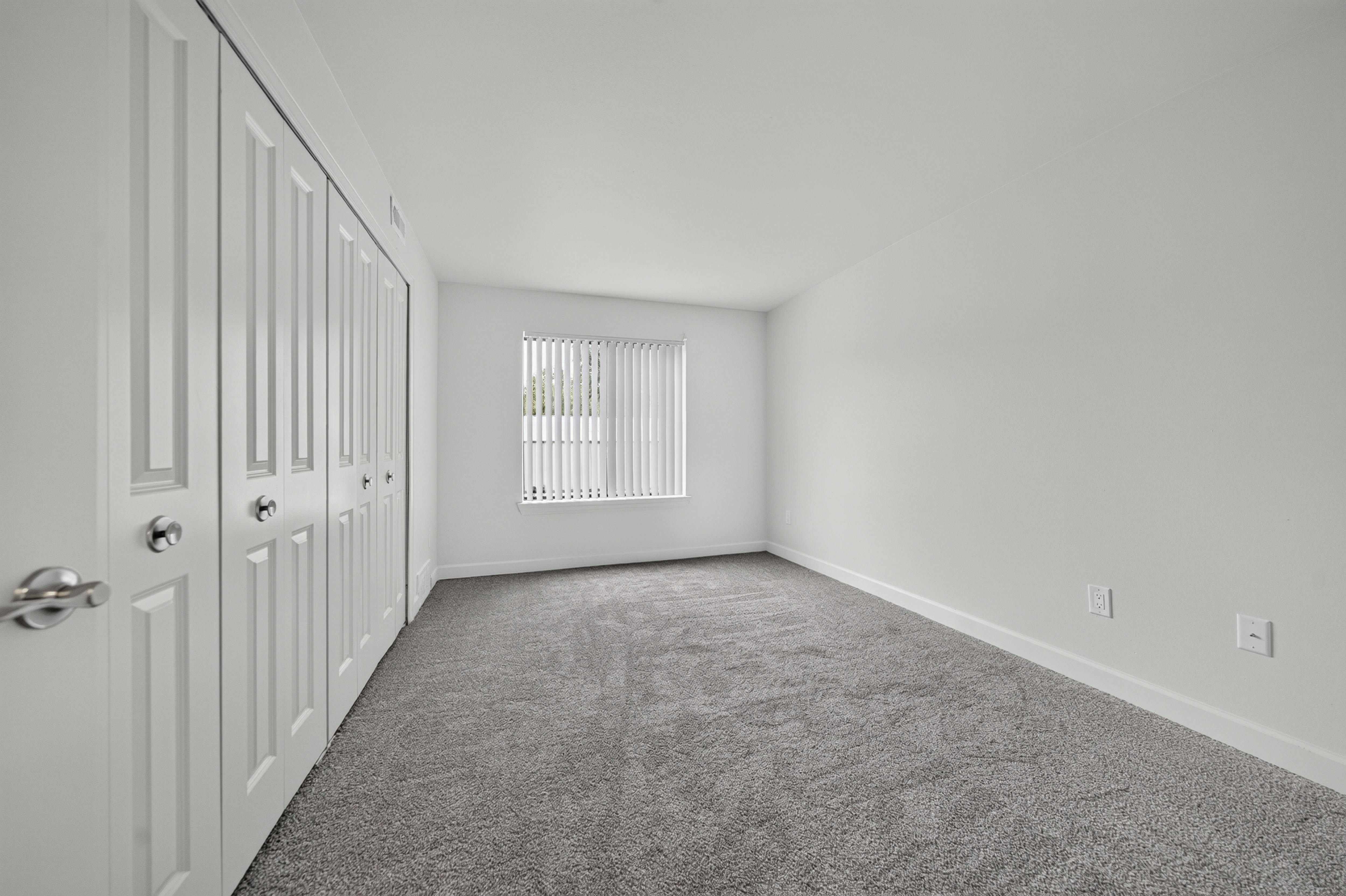 Bedroom with ample storage at Franklin River Apartments in Southfield, MI.