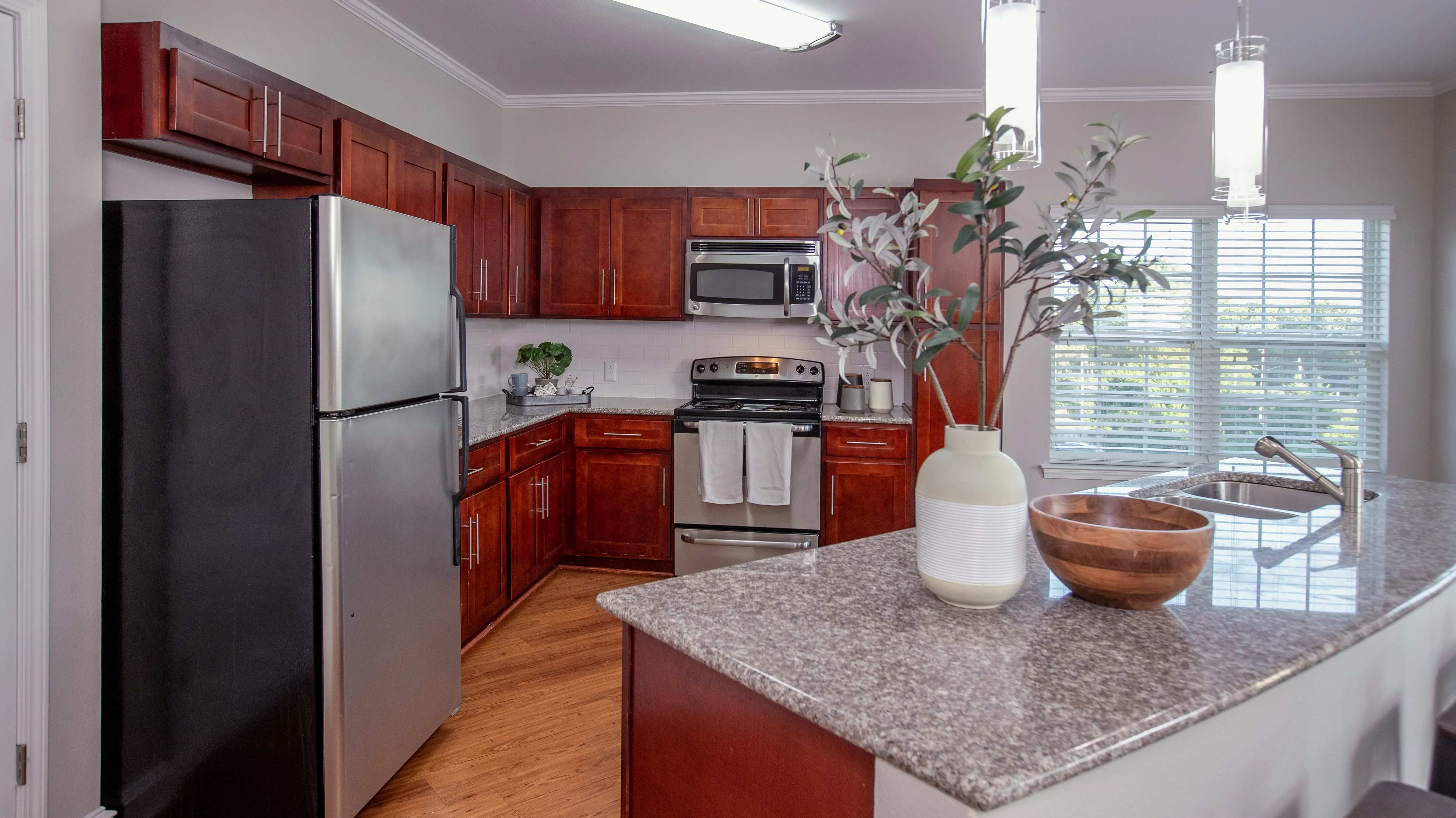 Entertain in style with our two-bedroom kitchens, boasting cherry wood cabinets and luxurious granite countertops for the perfect ambiance.