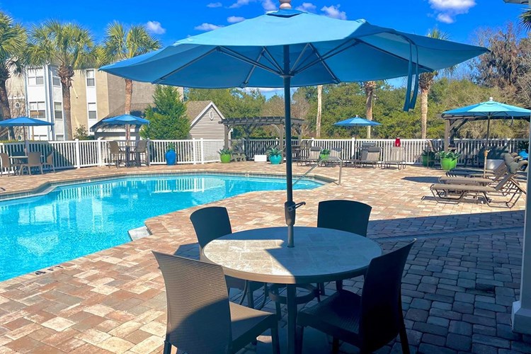Sit by the pool at one of our poolside tables with umbrella.