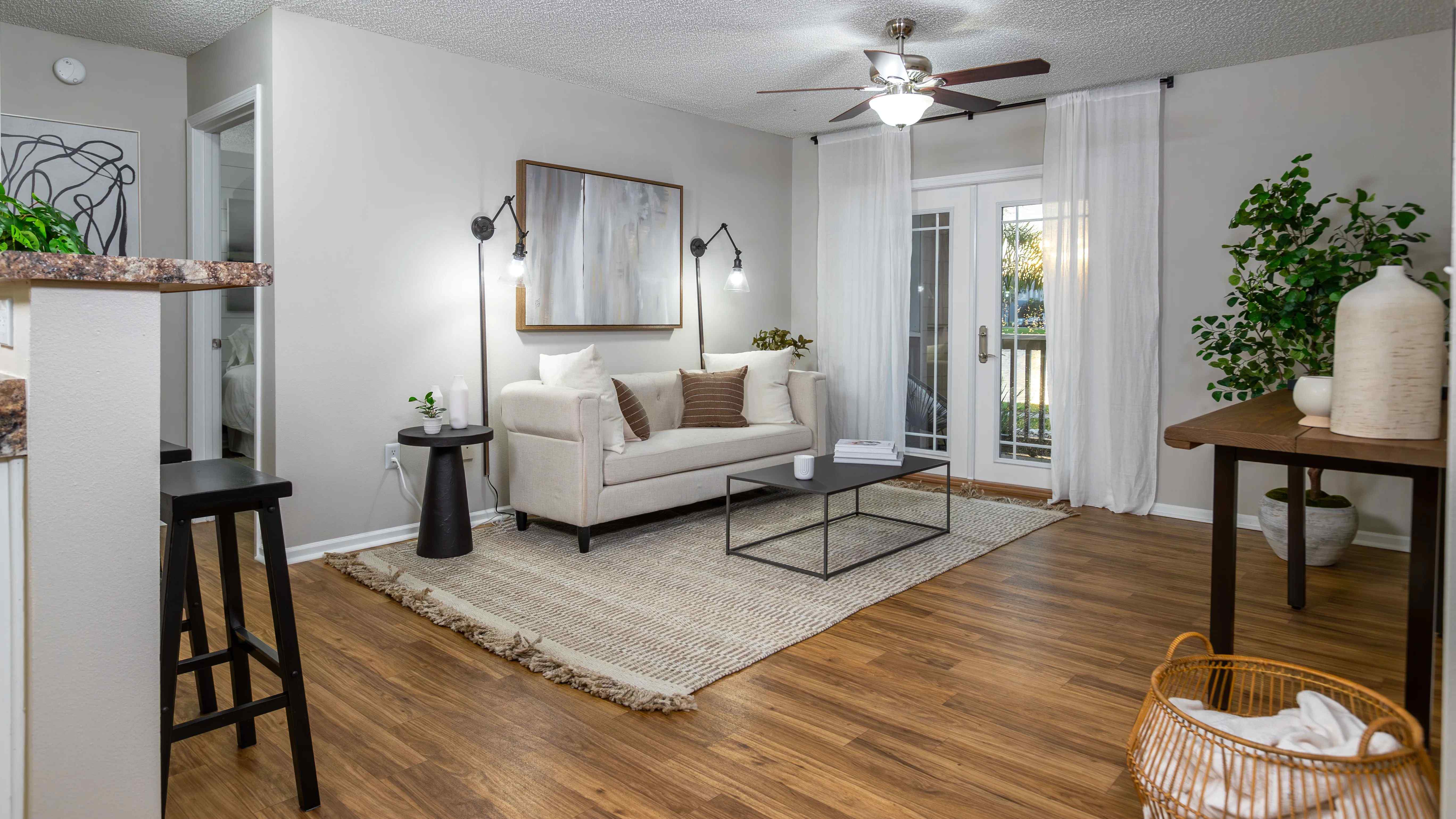 Step into comfort with this beautifully styled living room featuring wood-style flooring, natural light, and modern finishes—perfect for relaxing or entertaining.