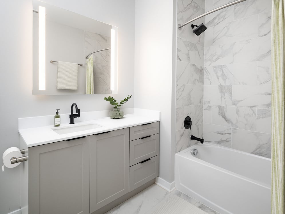 Signature Collection Guest bath with grey shaker cabinetry, white quartz countertop, and LED vanity mirror