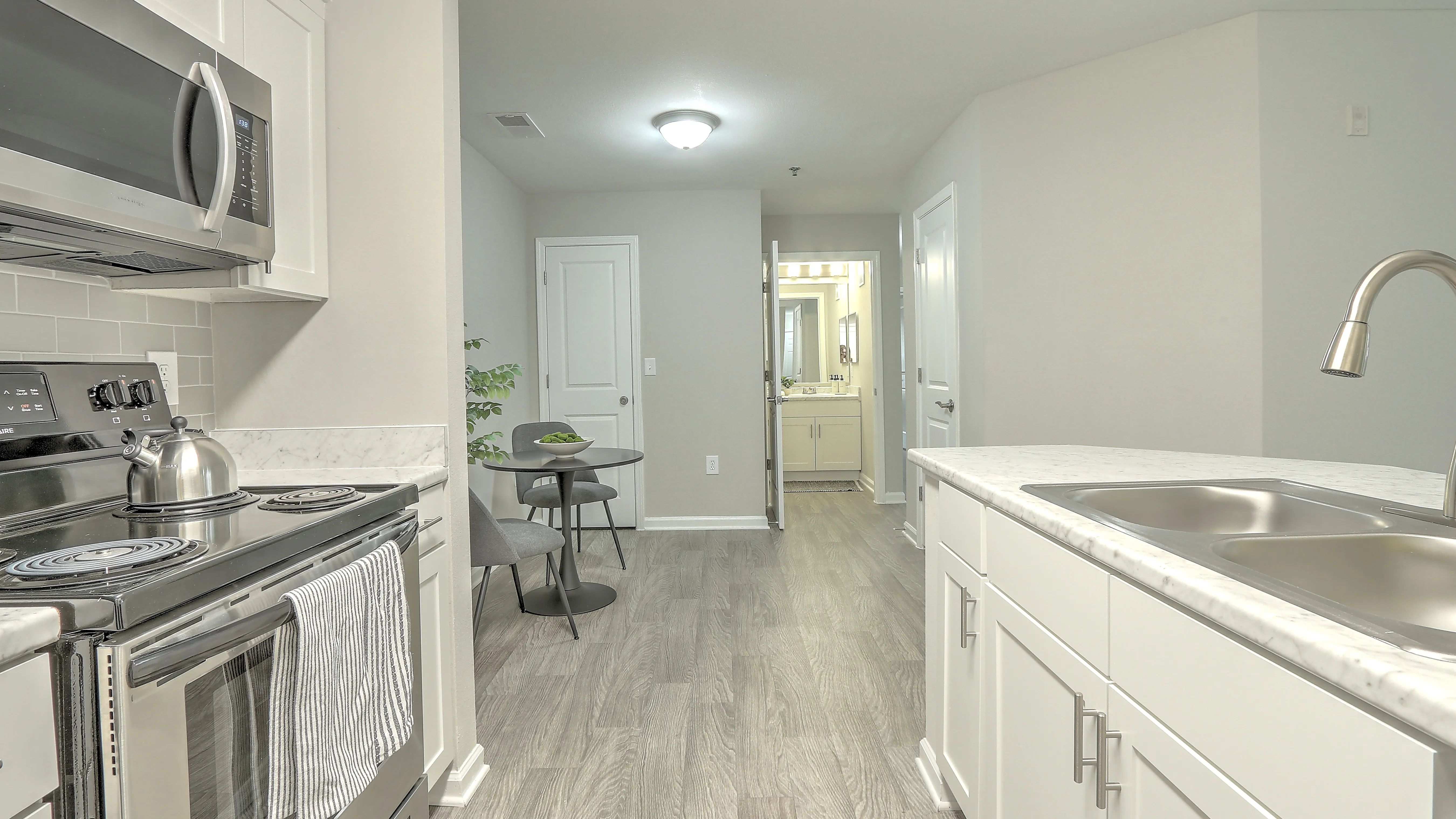 Relish an elegant dining area adjacent to your well-equipped kitchen with an extra storage closet for maximum convenience.