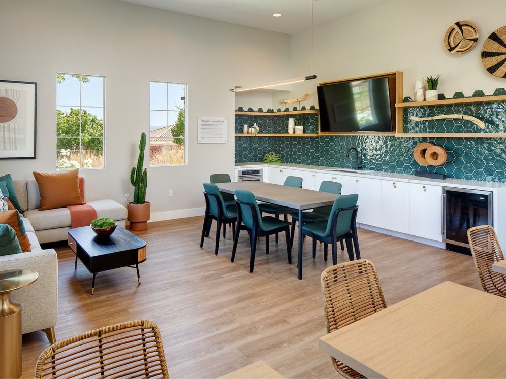Resident lounge with entertaining kitchen, dining area, and lounge seating