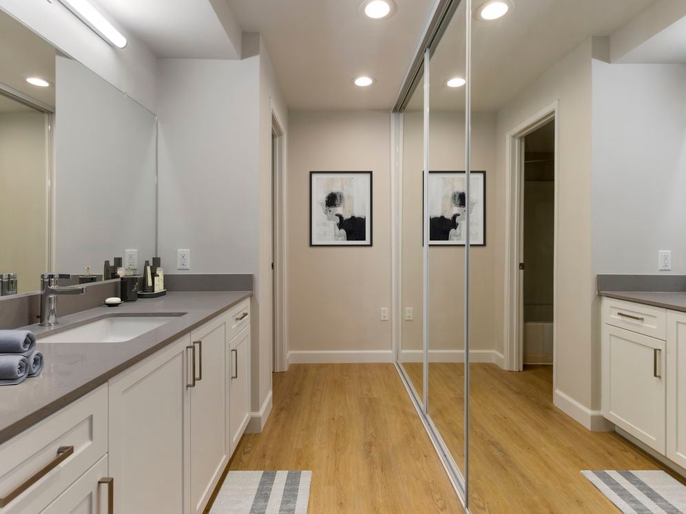 Bath with white cabinetry, grey quartz countertops, and hard surface flooring (Select Home)