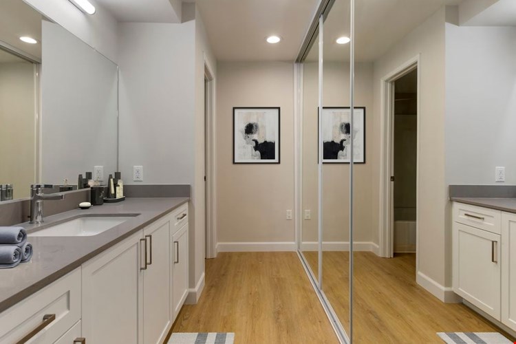 Bath with white cabinetry, grey quartz countertops, and hard surface flooring (Select Home)