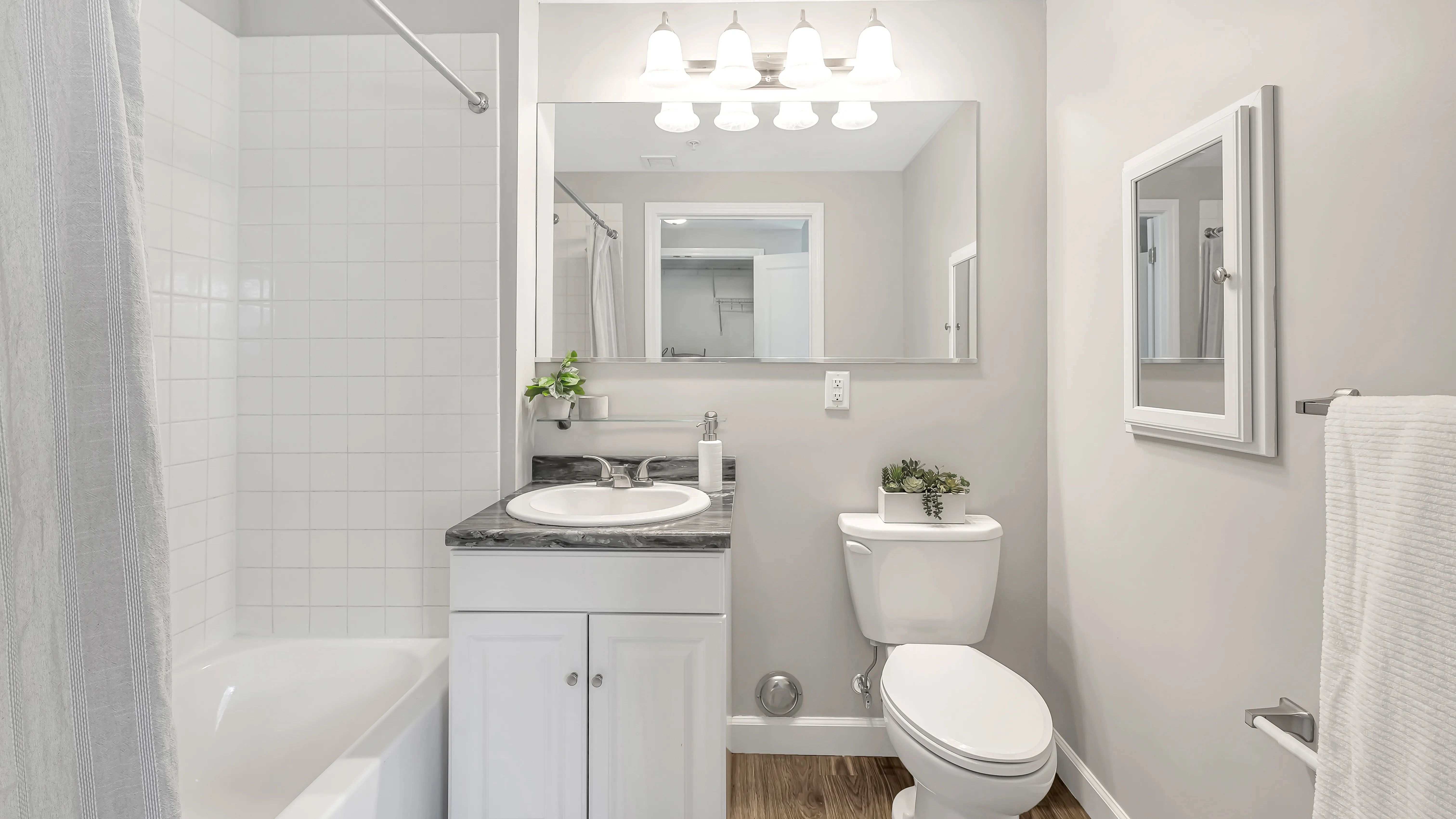 No matter what the day has in store, get ready for the day and feel at your best in your own brightly lit bathroom with white tile surround, large mirror, and personal medicine cabinet to store all of your essentials.