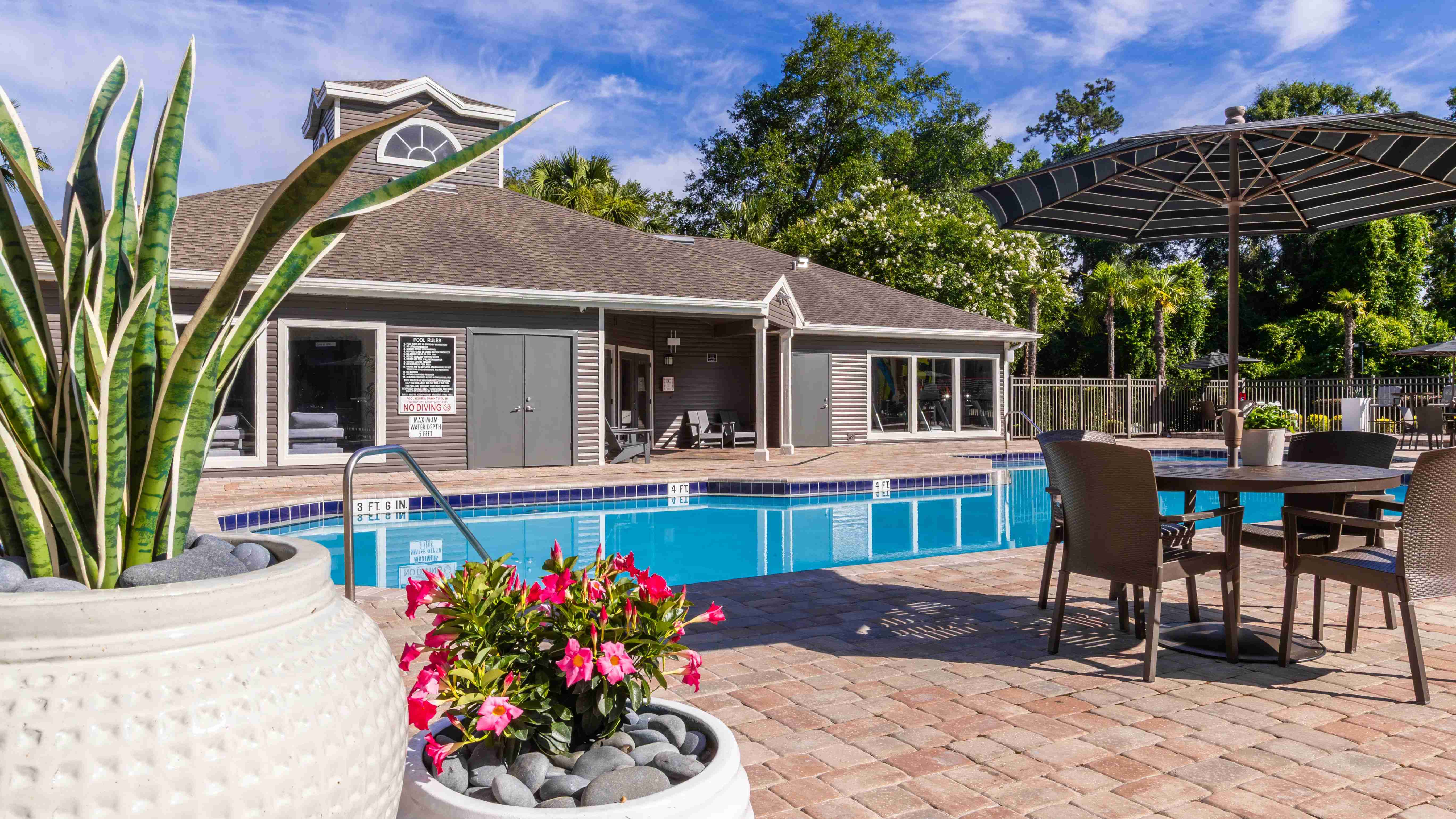 Unwind at one of our poolside tables with umbrellas, offering the ideal mix of comfort and shade on warm Florida afternoons.