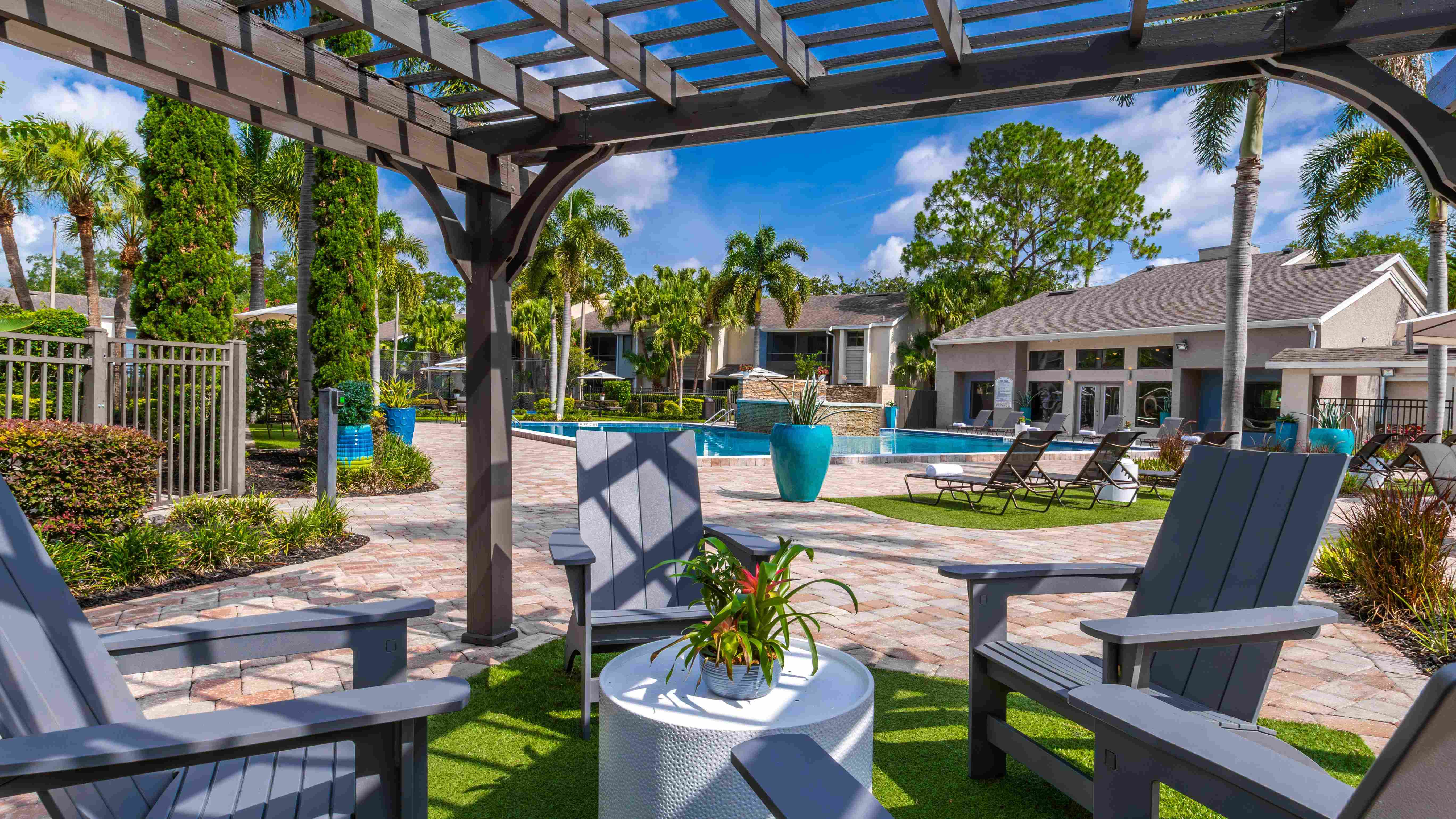 Soak up the resort lifestyle with peaceful poolside seating nestled under a shaded pergola and surrounded by tropical landscaping.