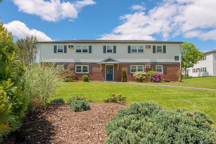 Exterior of our 1  bedroom buildings featuring lush landscaping.