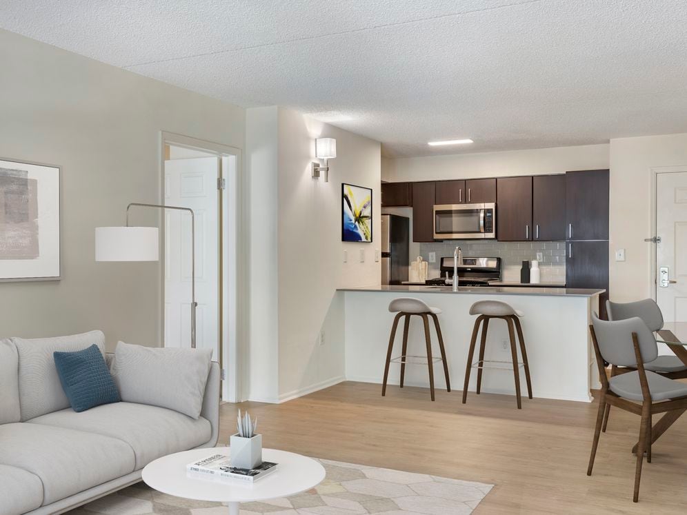 Renovated Package II kitchen, living, and dining areas with hard surface plank flooring