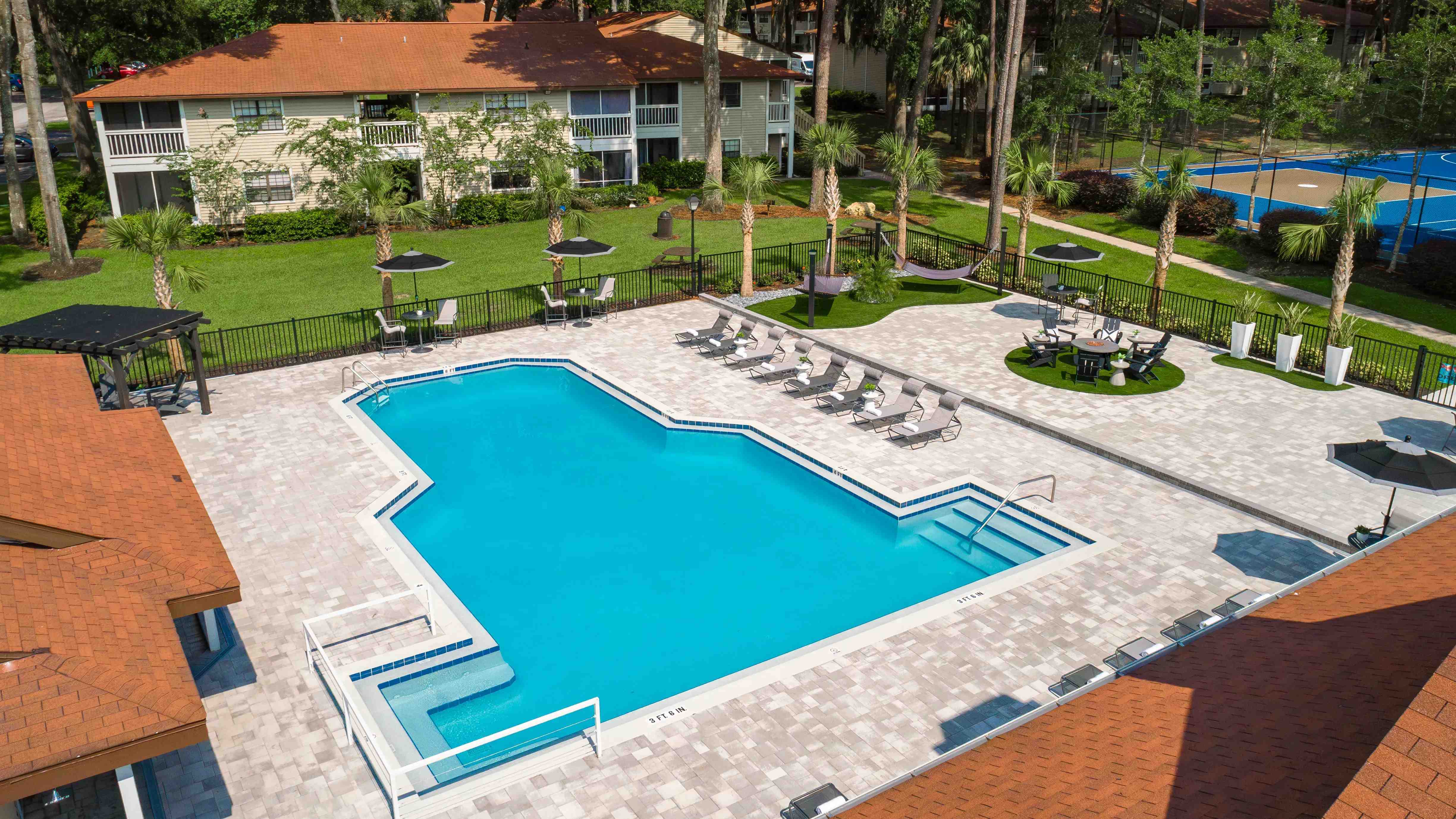 An enchanting aerial view of our resort-style pool and expansive sundeck, promising endless fun.