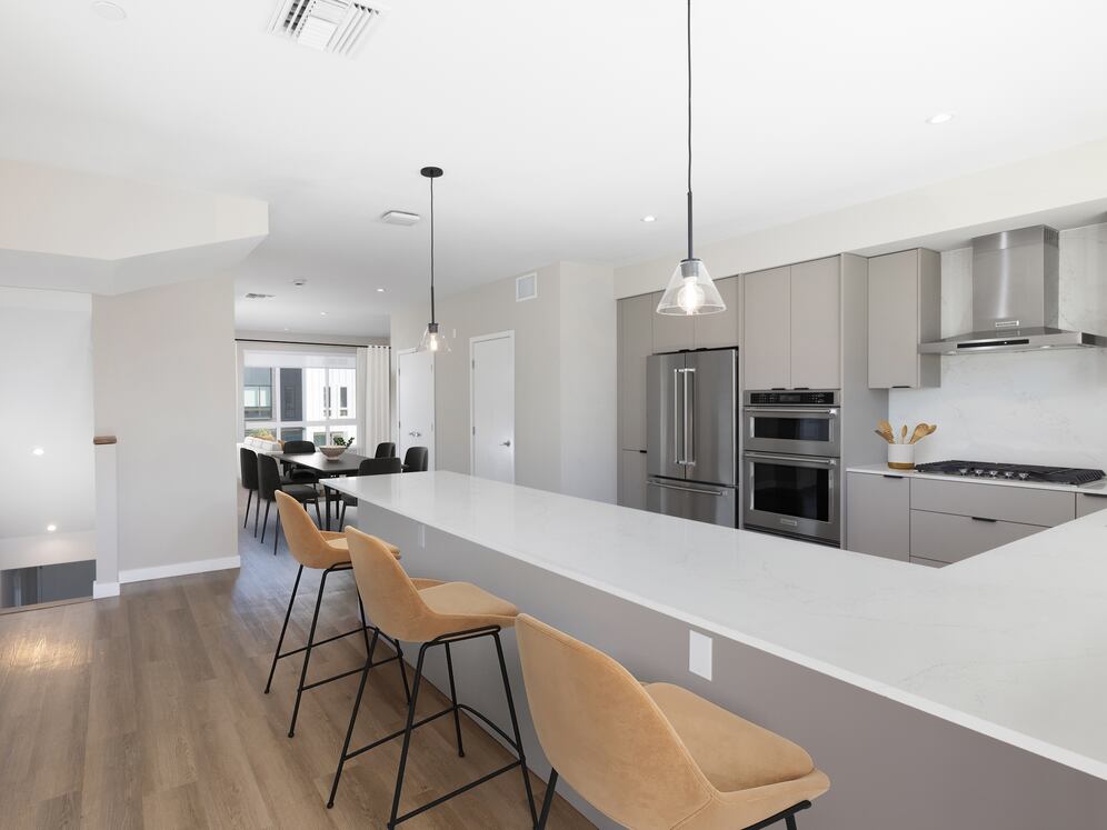 Signature Collection I 4-Bedroom Townhome Kitchen, dining, and living areas with hard-surface vinyl plank flooring