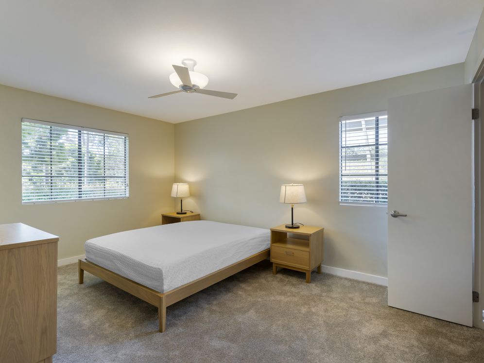 Furnished+ apartment homes feature queen bed with mattress, dresser, nightstands, and lamps (Representative Image – exact items and style of furnishings may vary)