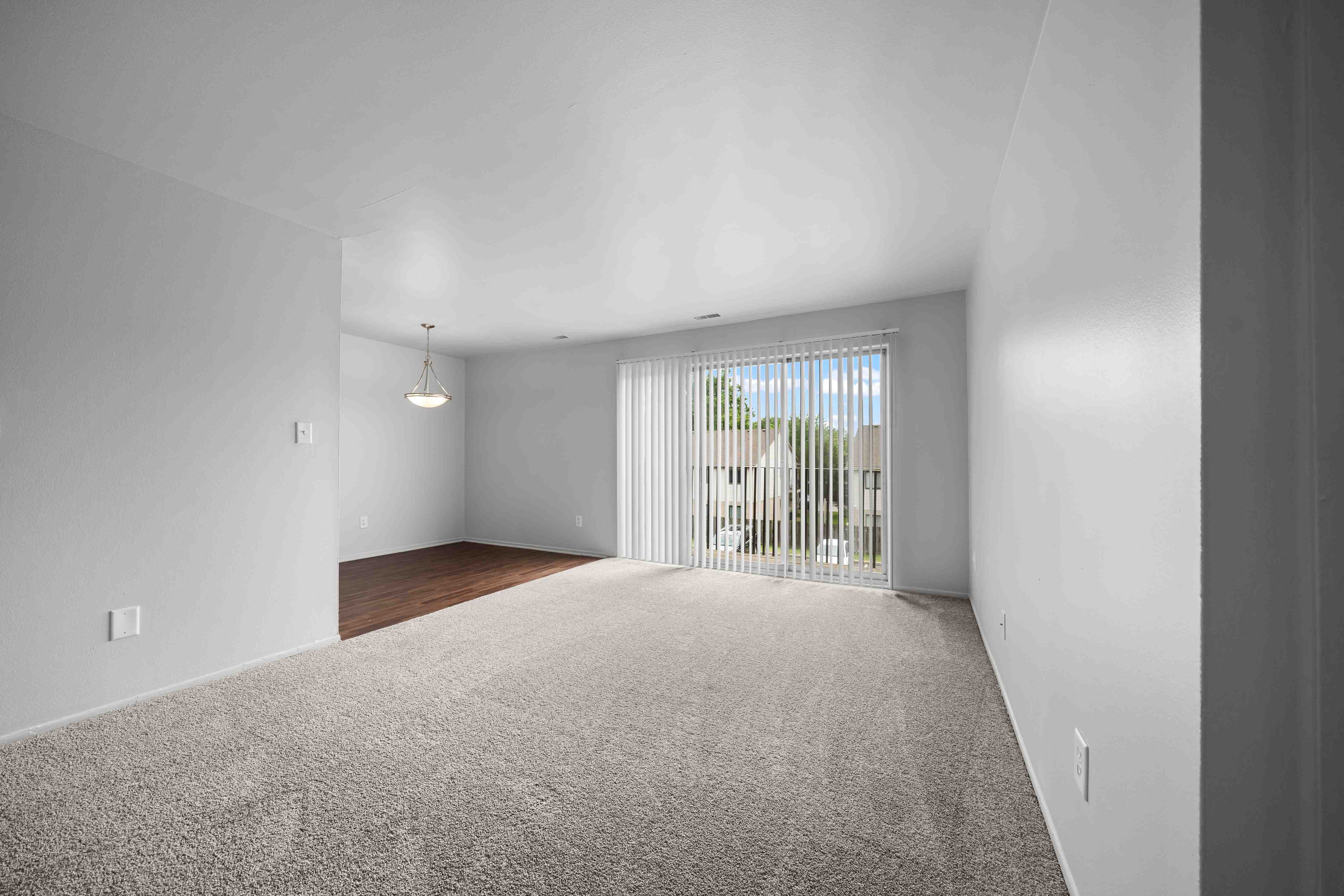 Open and airy living room with natural lighting at Knottingham Apartments in Clinton Township, MI.