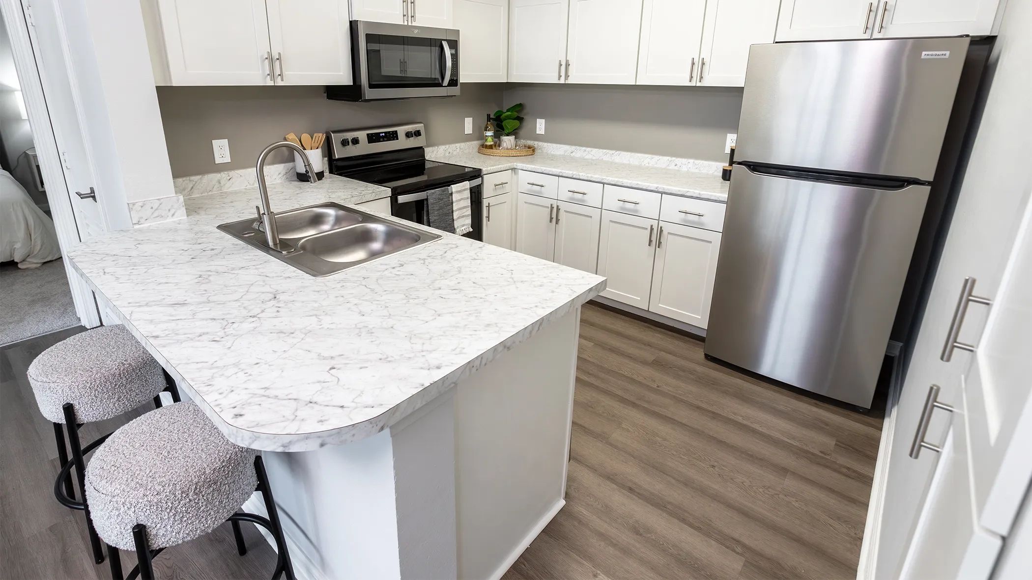 Enter a sleek kitchen oasis, boasting expansive countertop space, polished stainless-steel appliances, and abundant cabinetry. This space seamlessly merges elegance with the practicality you dream of in your ideal home - including a breakfast bar!