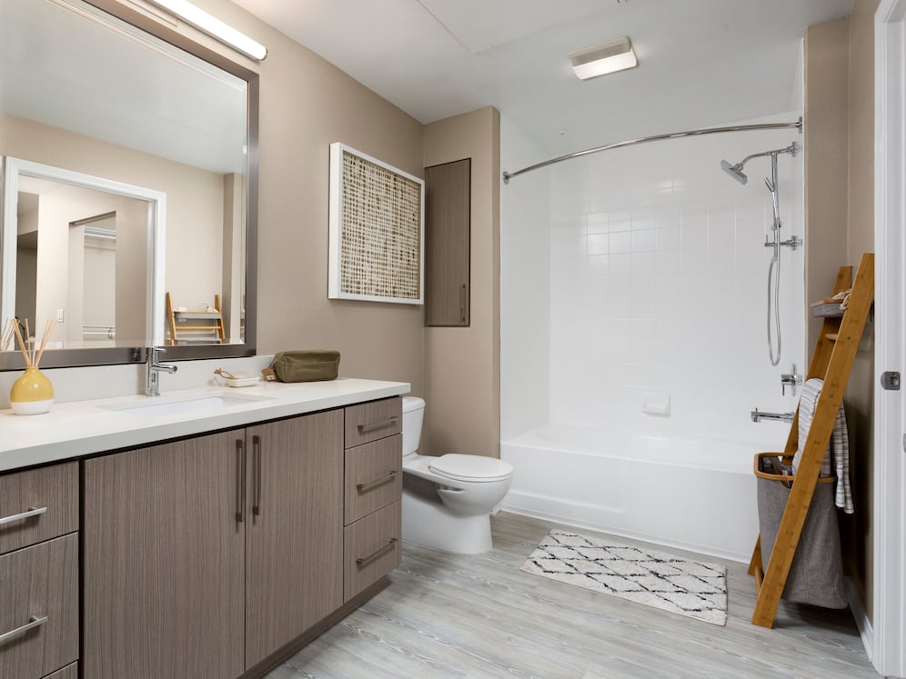 Design Scheme II bath with quartz countertops, new cabinets, and hard surface plank flooring