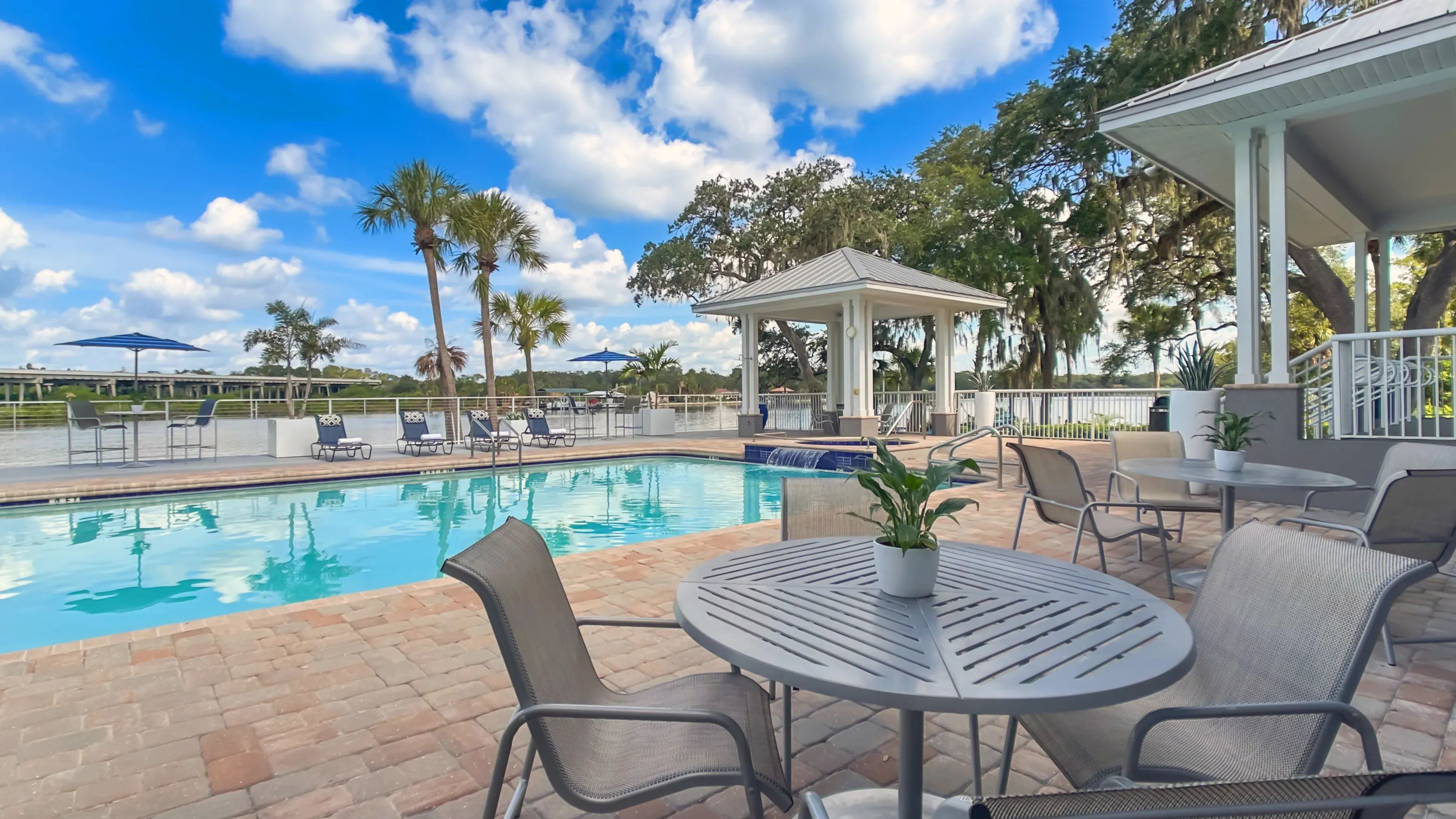 Bask in the open-air elegance and savor the panoramic river views from a variety of seating options around the sprawling pool deck.