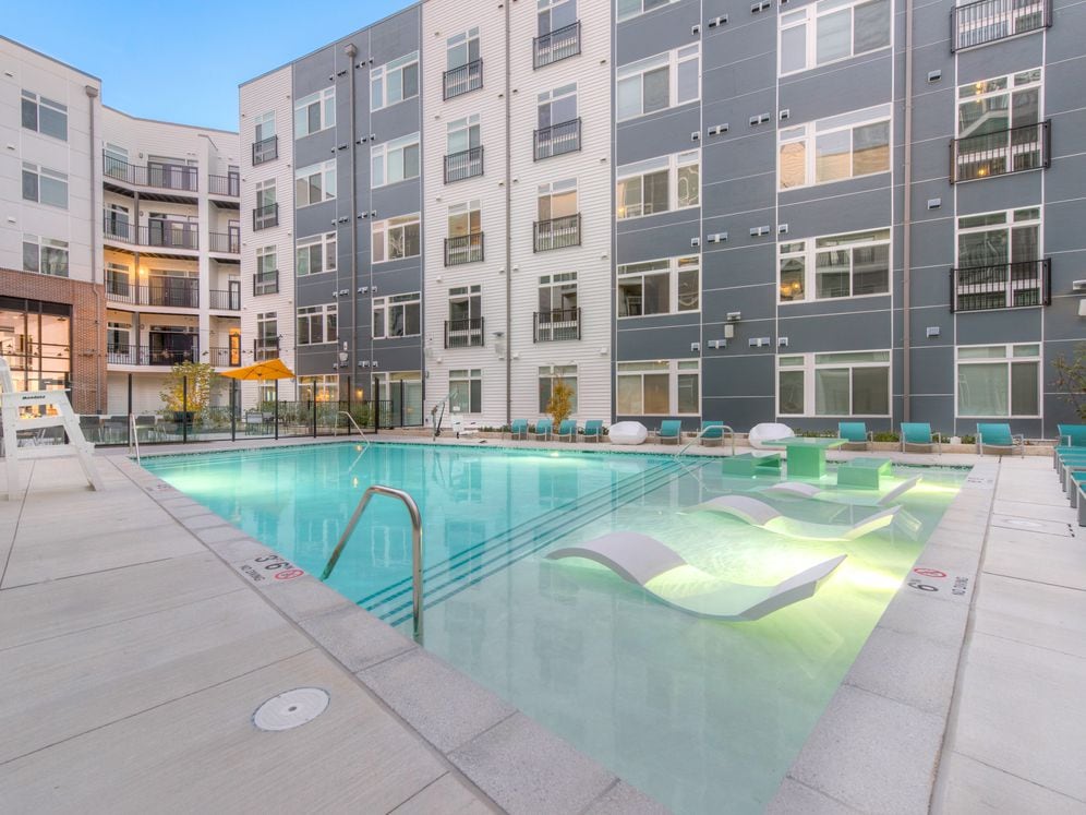 Courtyard with swimming pool, sundeck and lounge seating