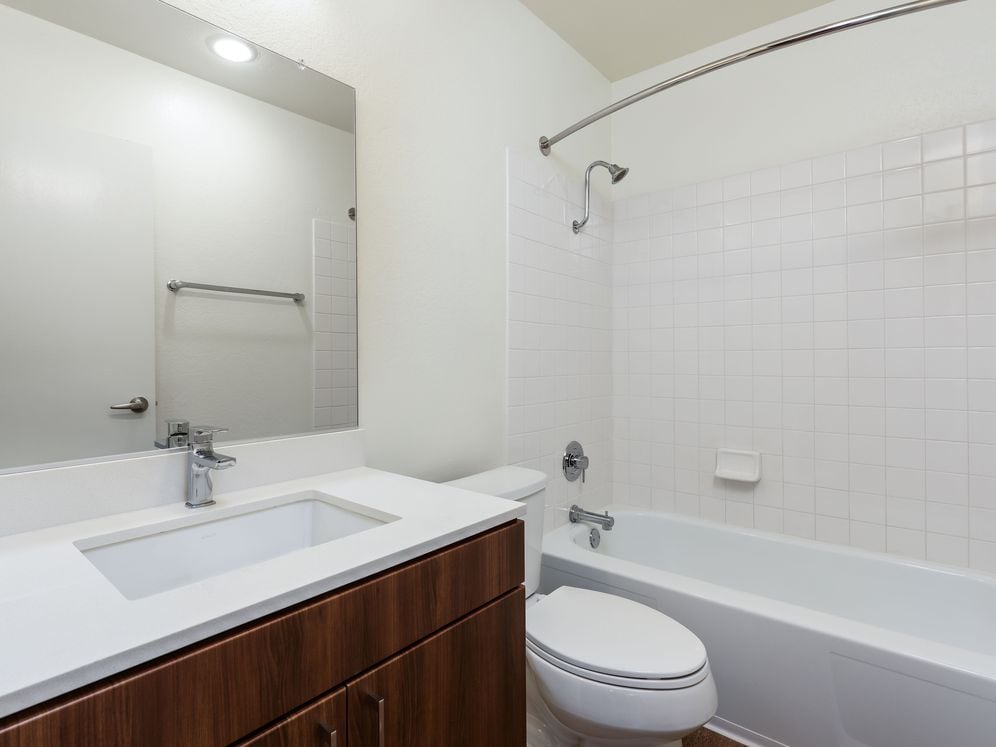 Renovated I bath with new cabinetry, quartz countertop, and hard surface flooring