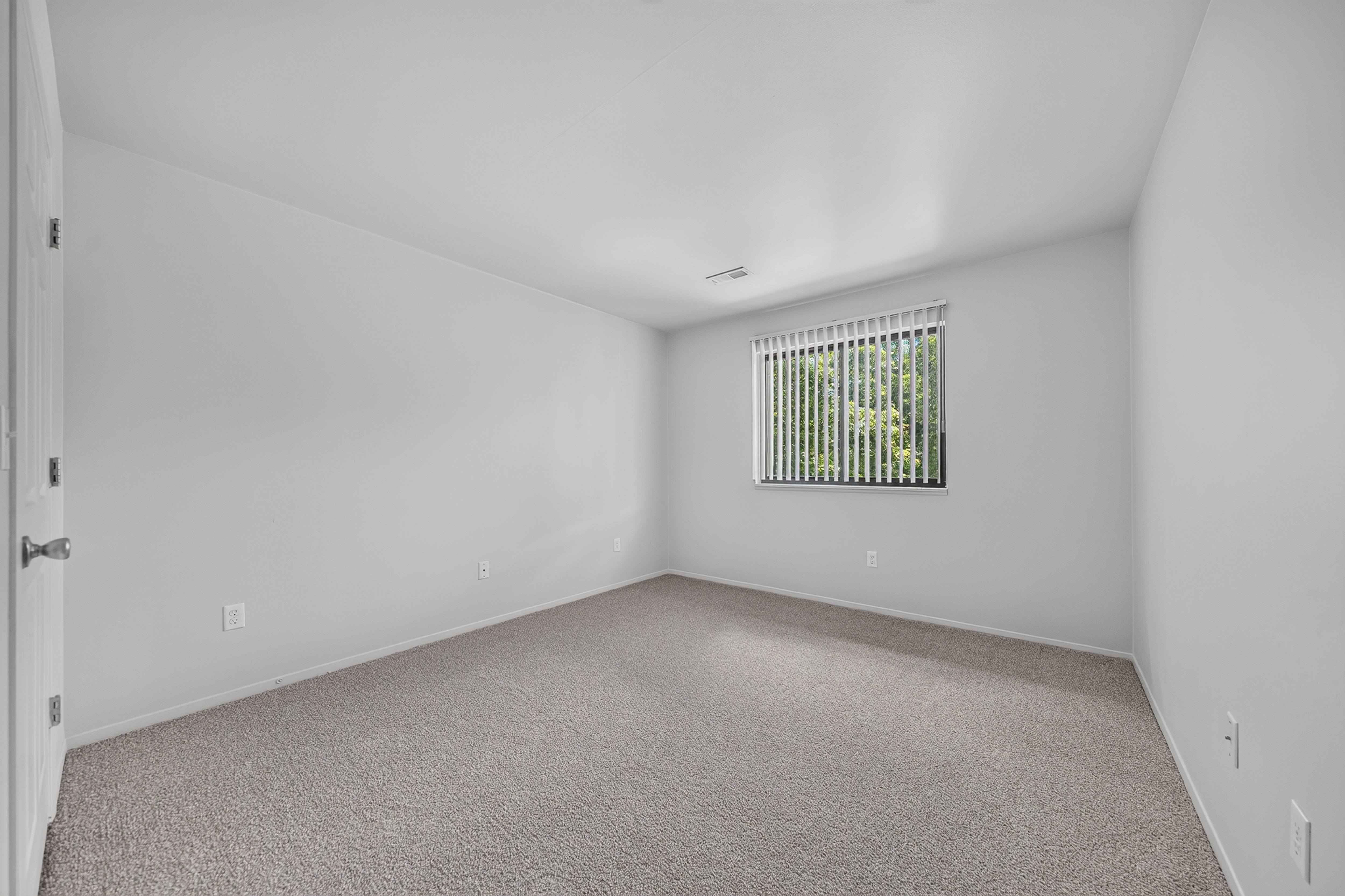 Spacious bedroom at Woodland Villa Apartments in Westland, MI.