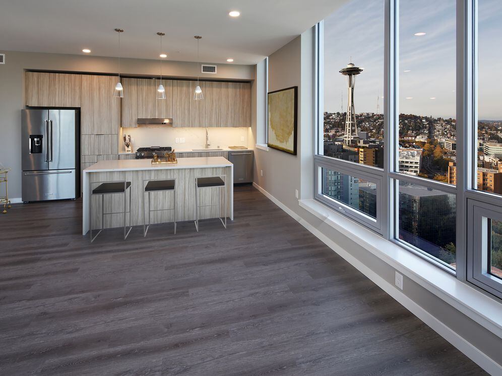 Signature Collection penthouse kitchen and dining area with hard surface flooring.
