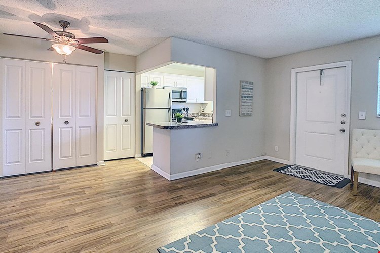 Separate dining room featuring wood-style flooring and a ceiling fan.