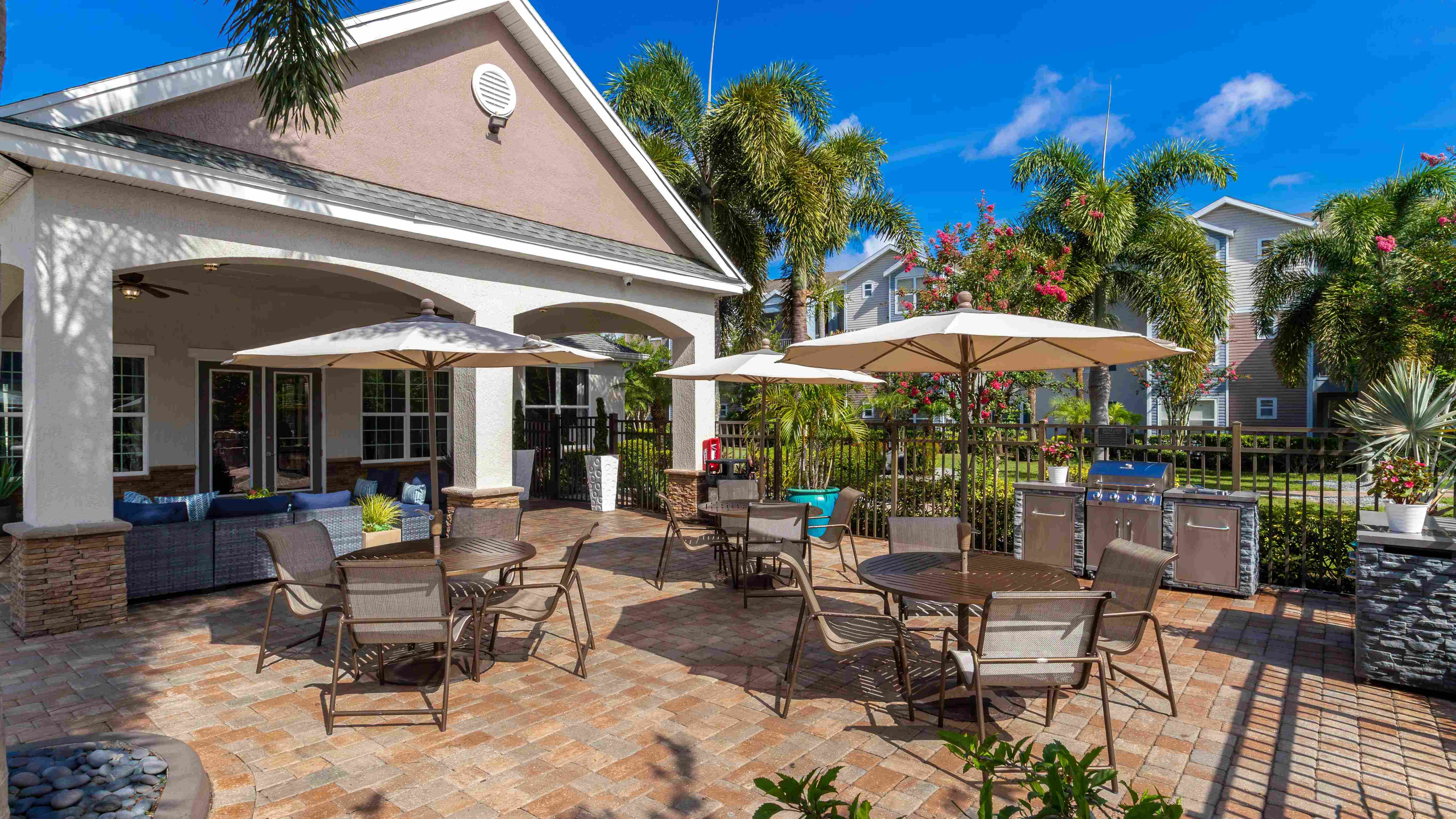Fire up the grill and gather around with friends in this beautifully designed poolside barbecue area.