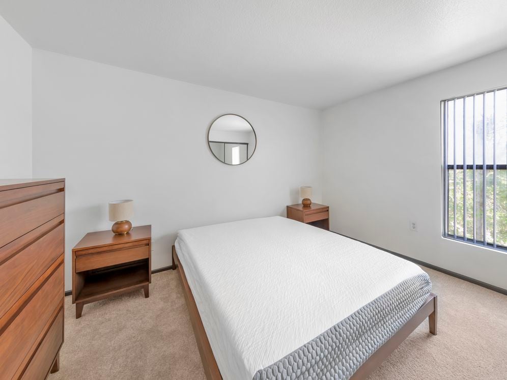 Furnished+ apartment homes feature queen bed with mattress, dresser, nightstands, and lamps (Representative Image – exact items and style of furnishings may vary)