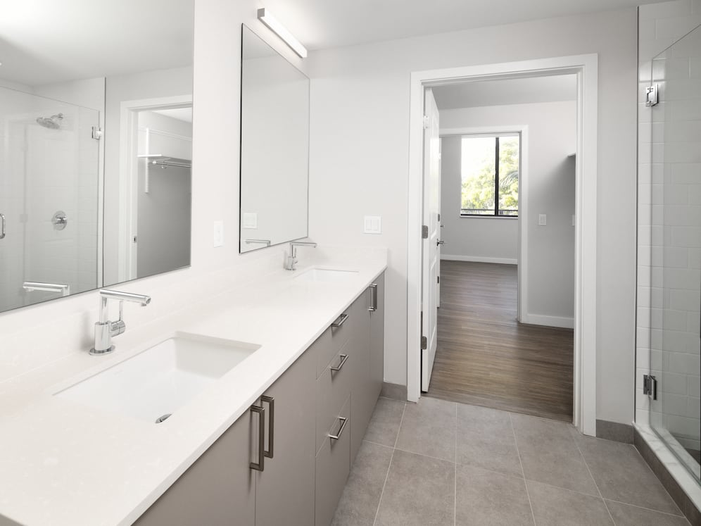 Upgrade Collection I bath with double-sink vanity, white quartz countertops, and standing shower