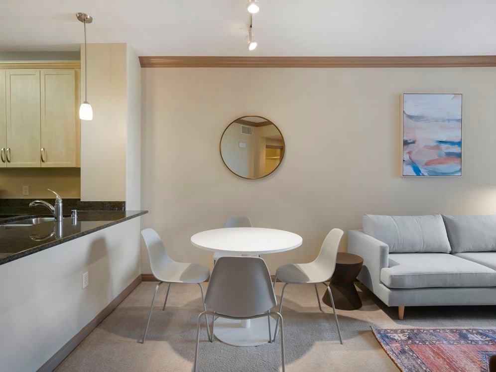 Furnished+ apartment homes include a dining set (Representative Image – exact items and style of furnishings may vary)