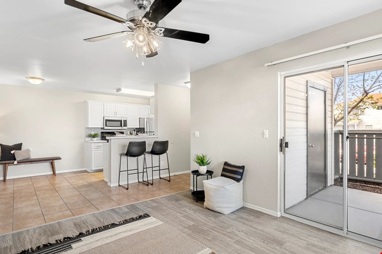 Sunlit open floor plan with tiled dining area, connecting effortlessly to the living room and kitchen.