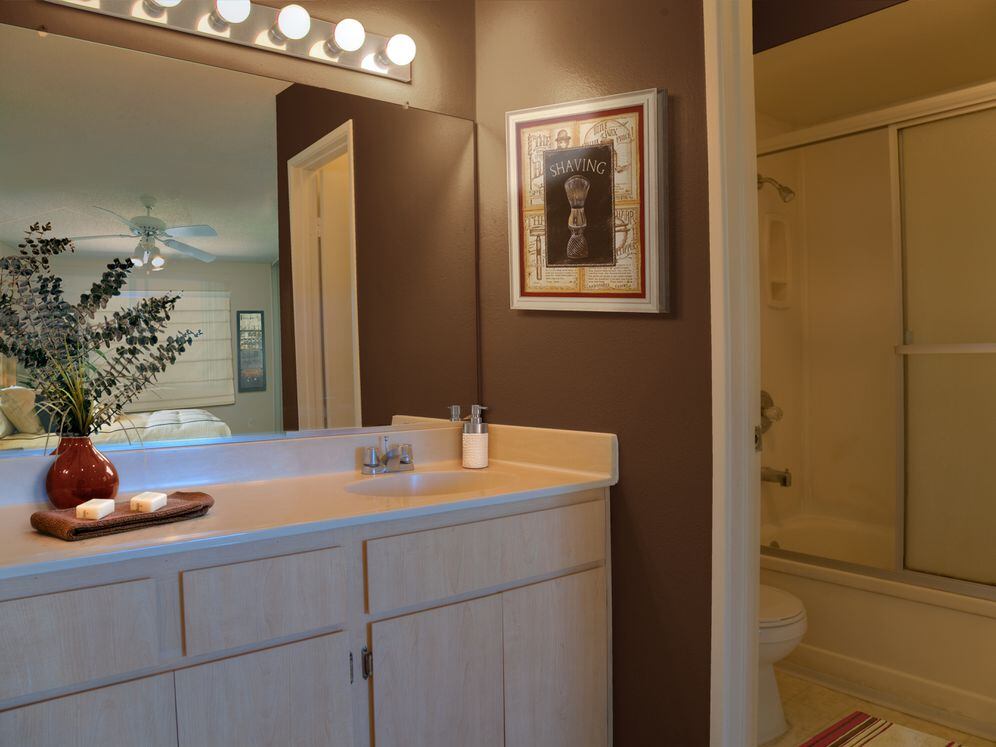 Classic Package I bath with oak cabinetry, white laminate countertops, and hard surface flooring