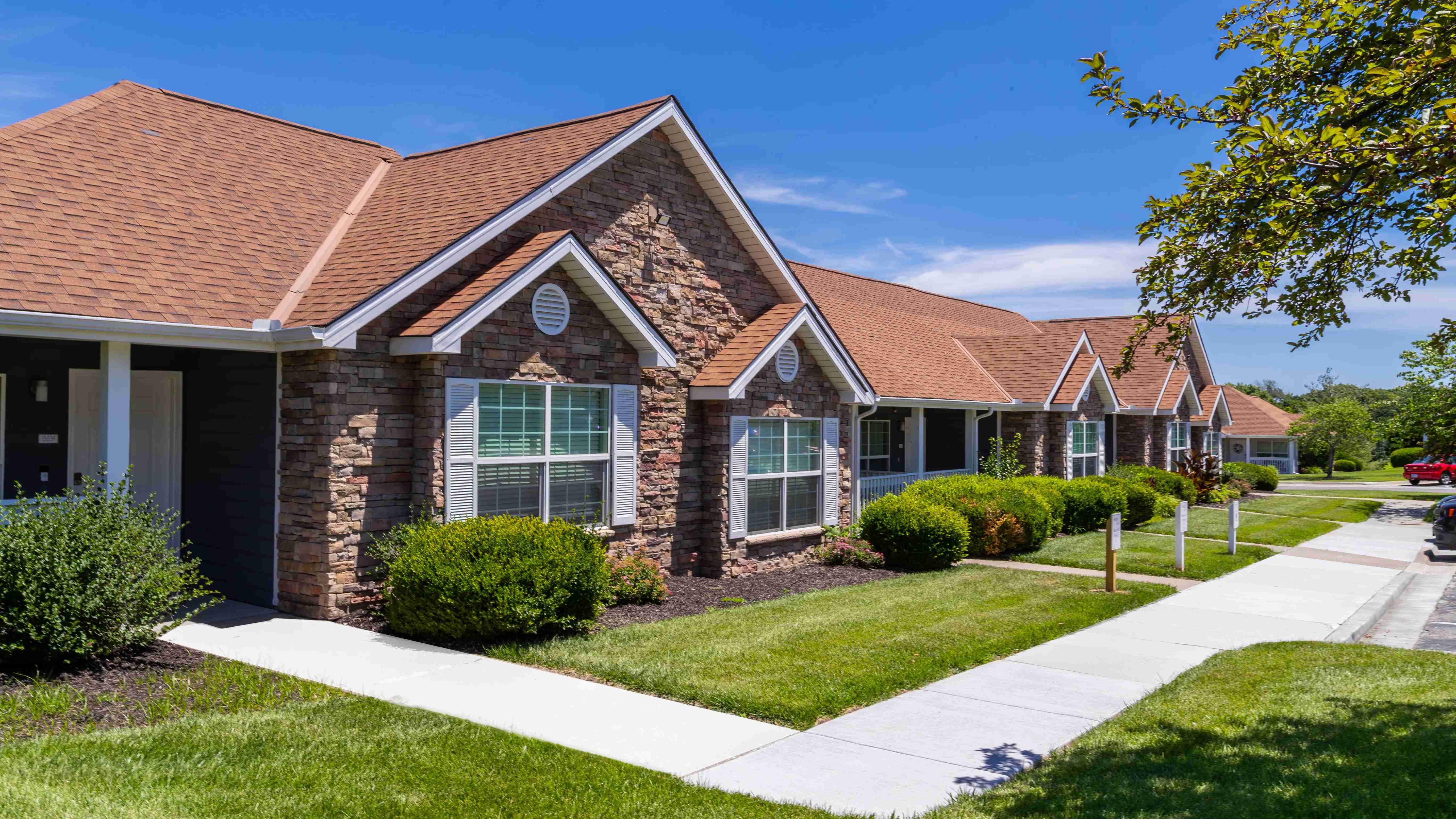 Experience the charm of Lenox West with our beautifully designed, stone-accented homes, surrounded by lush greenery and well-maintained pathways.