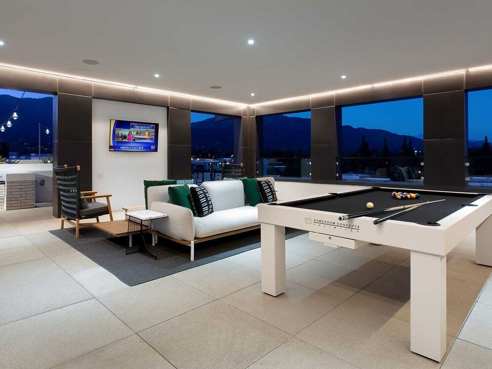 Rooftop indoor lounge with game area and lounge seating