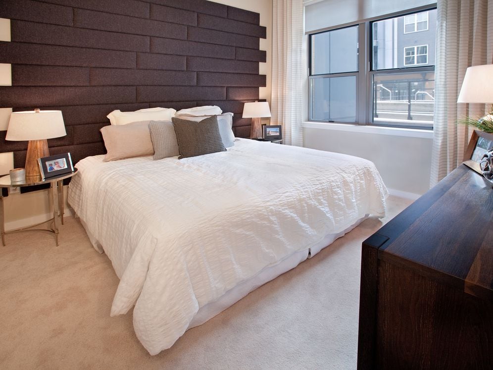 Bedroom with accent wall and carpet