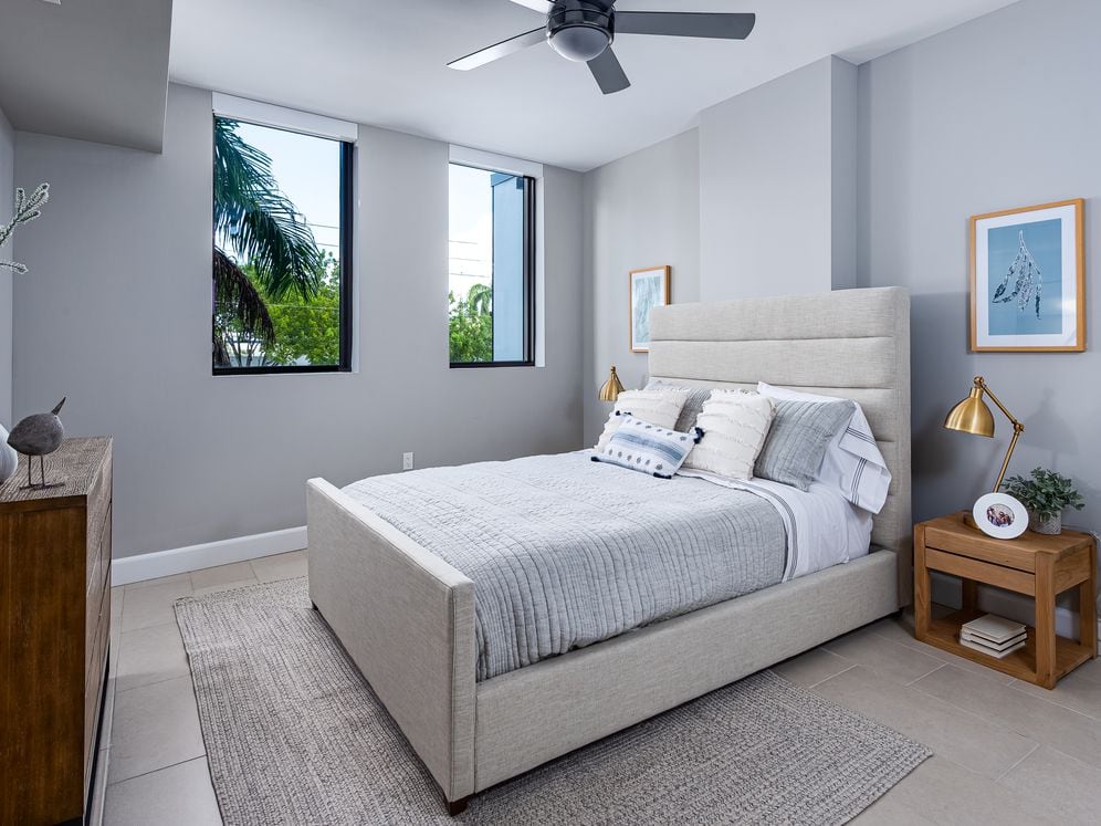 Spacious bedroom with hard surface flooring and ceiling fan