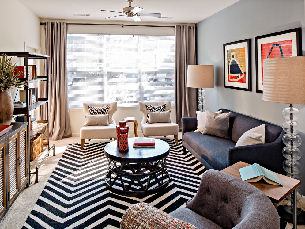 Living room with carpet (select homes)
