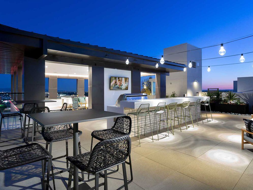 Rooftop terrace with grills, seating and dining areas