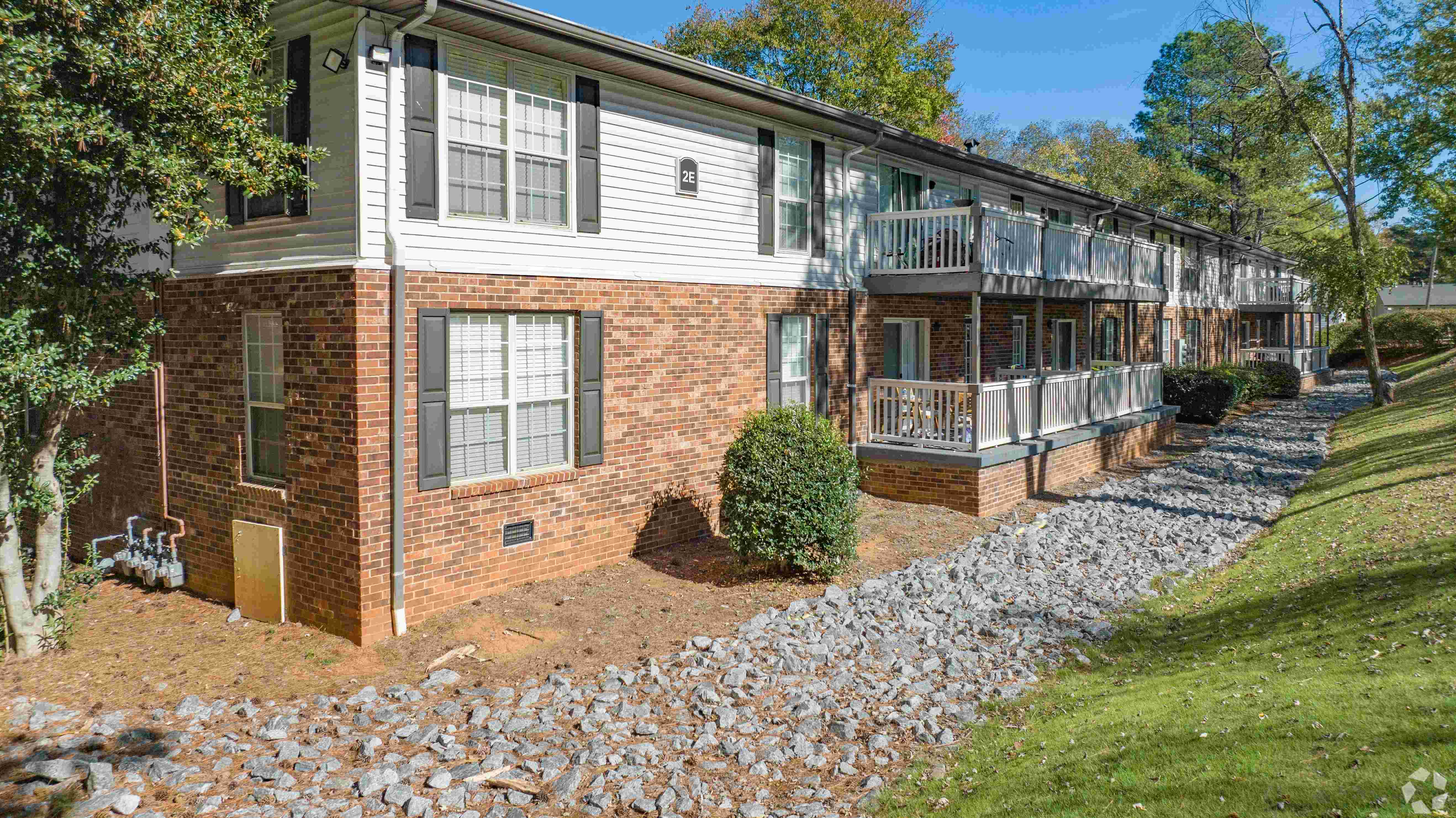 Discover the charm of Legacy at West Cobb Apartment homes, featuring a classic brick exterior and private balconies for each unit.