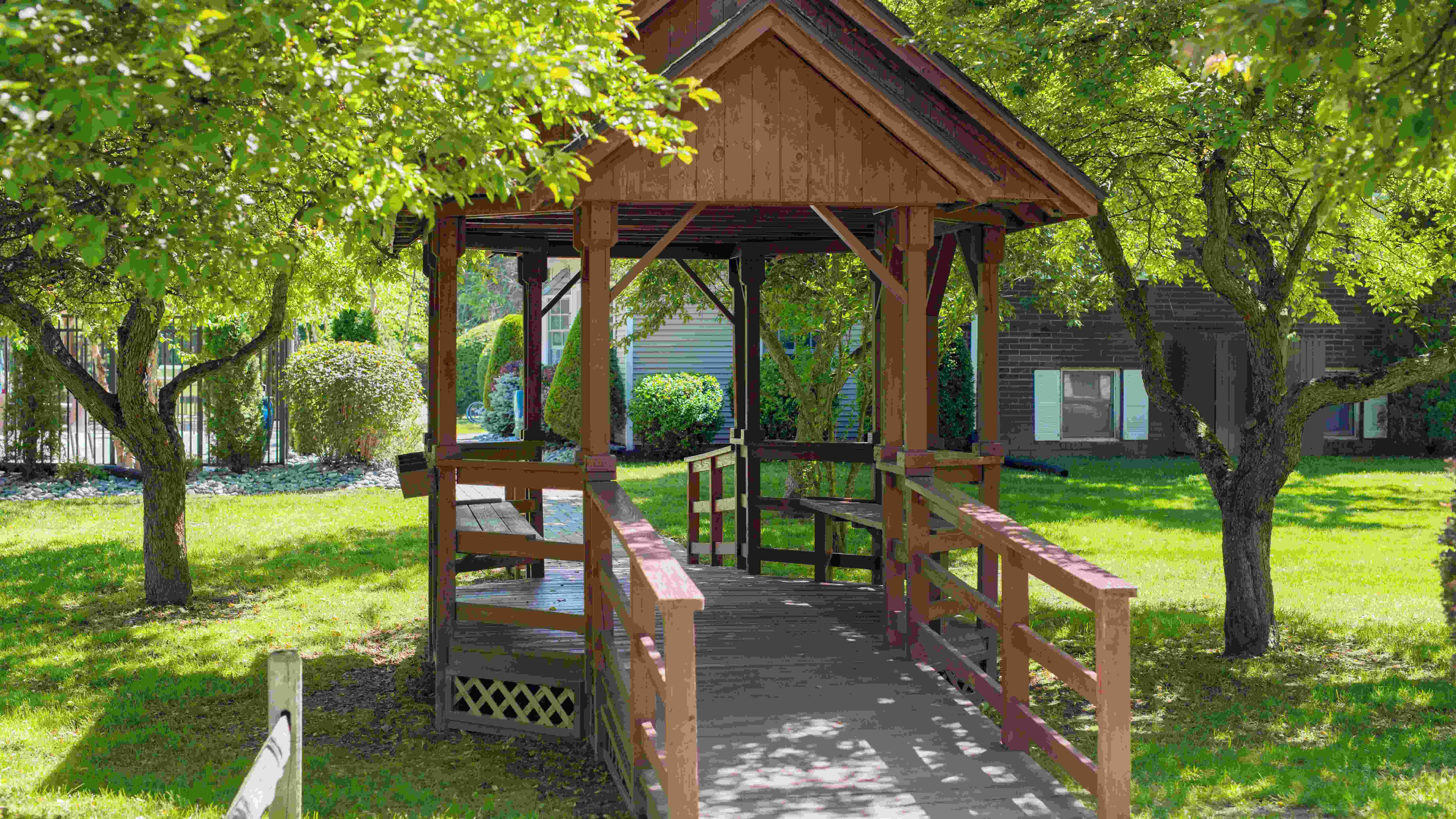 Relax in the shade under our charming gazebo, your perfect spot for outdoor tranquility. 