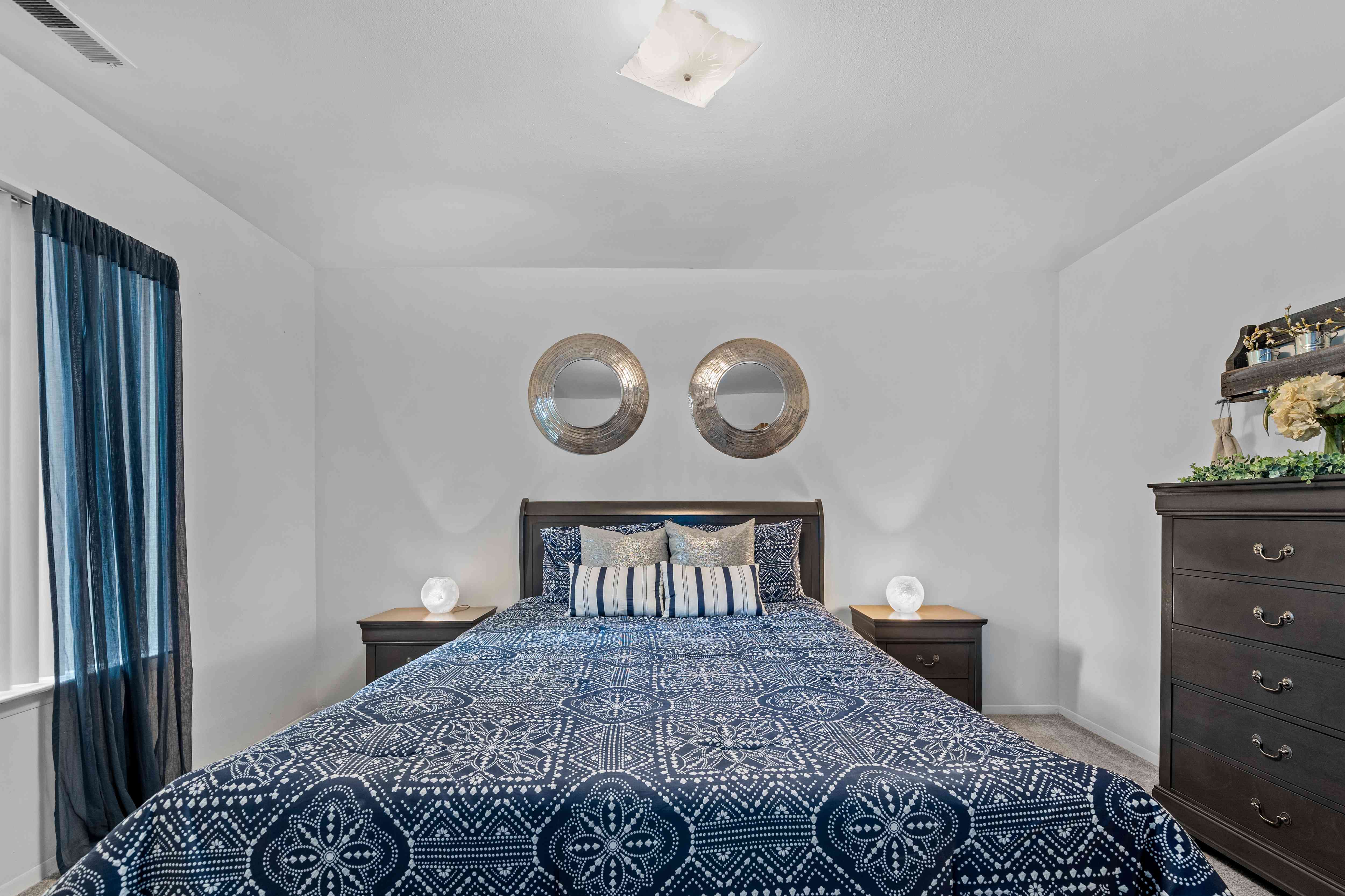 Comfortable bedroom with natural lighting at Westwood Village Apartments in Westland, MI