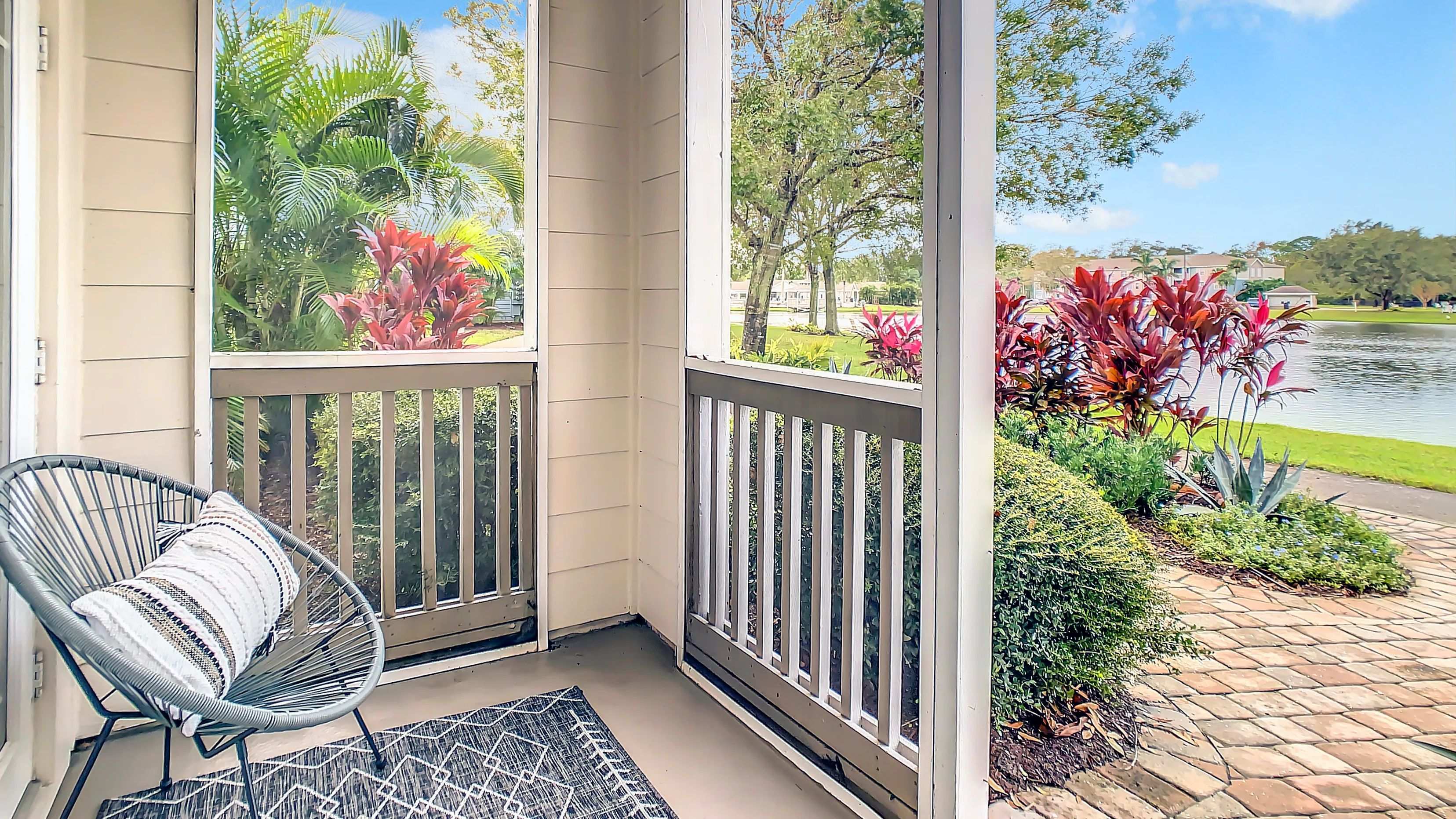 Discover secluded outdoor sanctuaries on your screened-in patio, offering a private retreat amidst serene lake views and lush greenery.