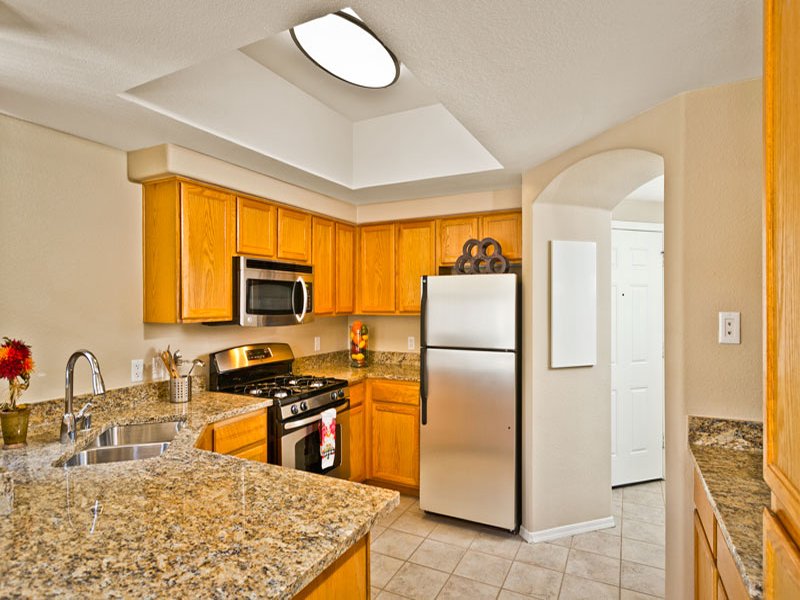Kitchen has beautiful counters and plenty of cabinet space