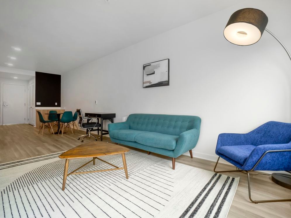 Furnished+ apartment homes come outfitted with a sofa, side chair, side table, coffee table, TV stand and 50" Television (Representative Image – exact items and style of furnishings may vary)