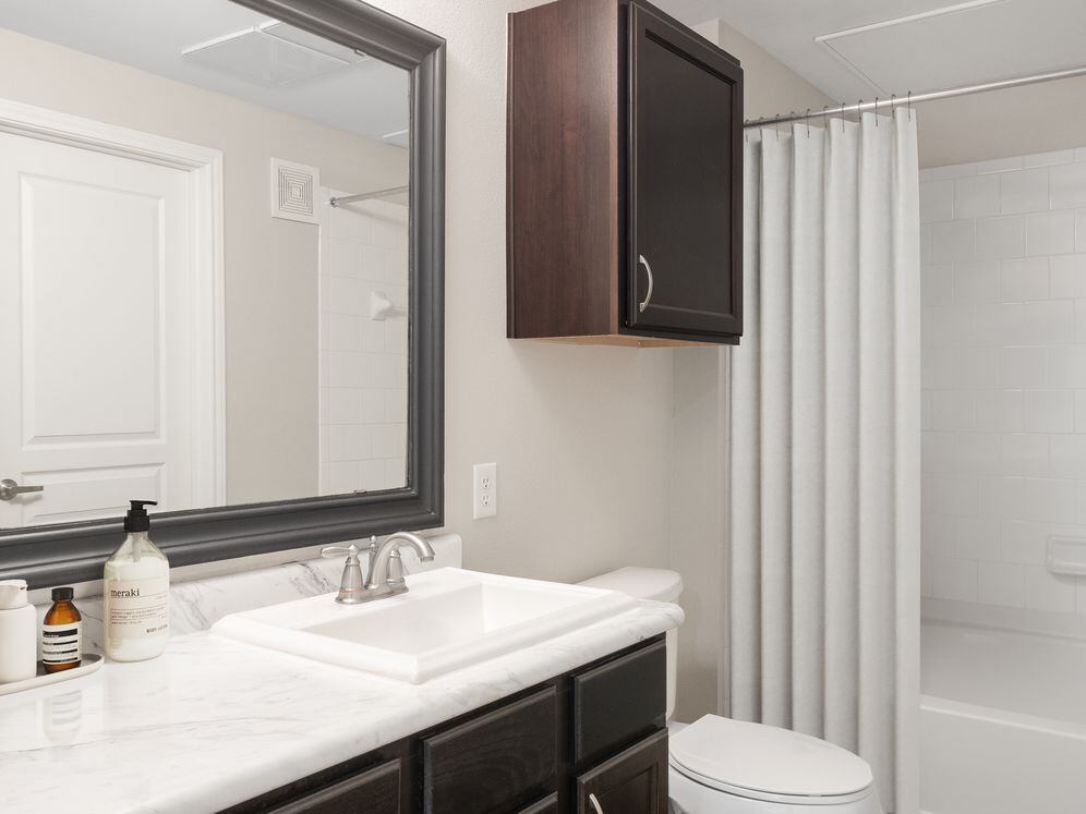 Bath with espresso cabinetry, quartz or granite countertop, and hard surface vinyl plank flooring